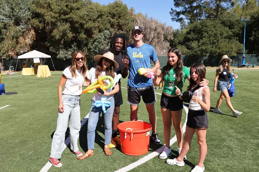 Student-athletes posing with participants